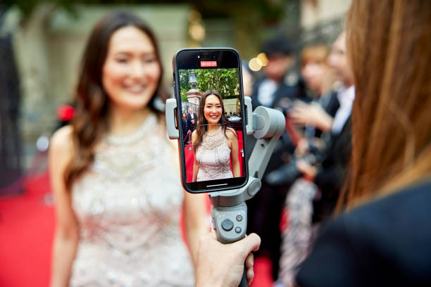 Mature celebrity interviewed by vlogger at red carpet event