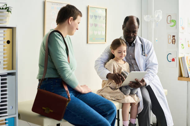istock Doctor Using Tablet While Consulting with Child and Parent 2169413635