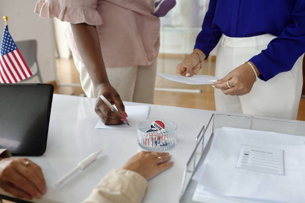 istock Voters Filling Bulletins During Election 2169417777