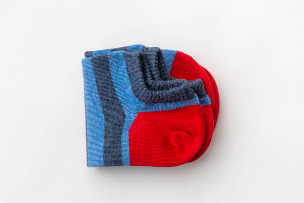 istock Folded blue and gray striped socks with red accents on white background 2169418323