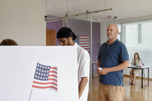istock People Standing In Queue To Vote In Booth 2169418744