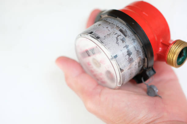 Bad condition water meter in woman's hand. Condensation between the cover and meter body. Verification of water meters. Shallow depth of field. Copy space.