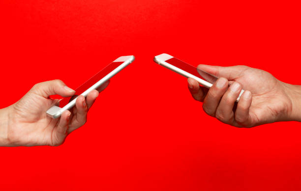istock Two Hands Holding Smart Phones 2169430998