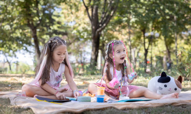 istock Joyful Sisters Playing Outdoors in a Summer Park 2169431086
