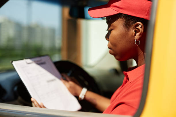 istock Reviewing Delivery Checklist While Sitting in Delivery Van 2169432630