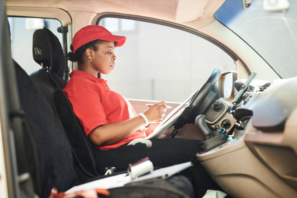 istock Reviewing Delivery Route in Delivery Van Cockpit 2169432638