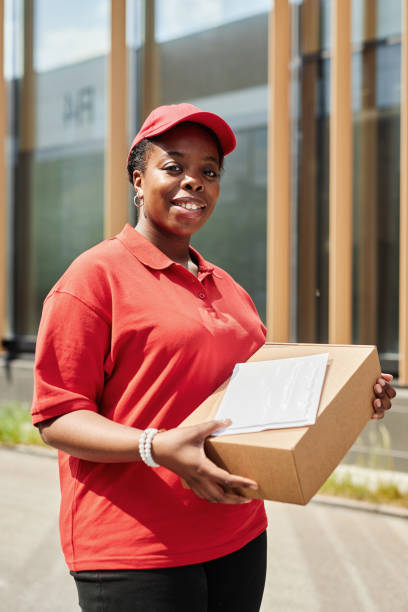 istock Smiling Delivery Worker Holding Package Outdoors 2169432681