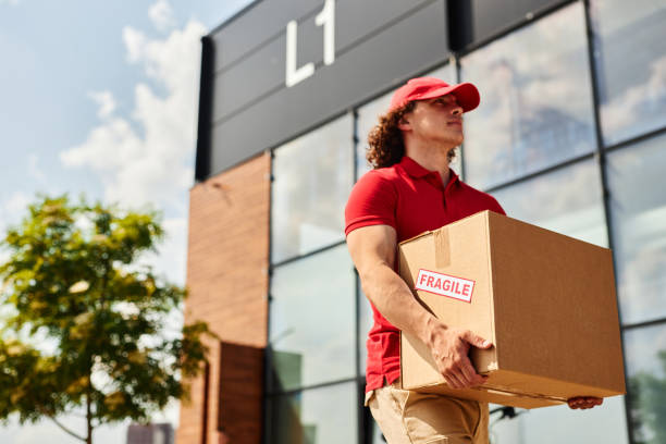 istock Delivering Package Outside Modern Building in Sunny Day 2169432732
