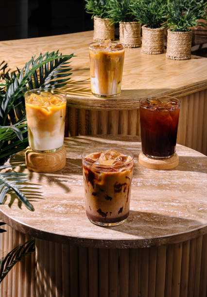 istock Four iced coffee drinks sitting on a cafe table in the sun 2169433312