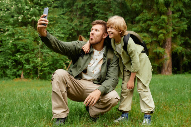 istock Father and Son Taking a Selfie in Outdoor Forest Setting 2169434145