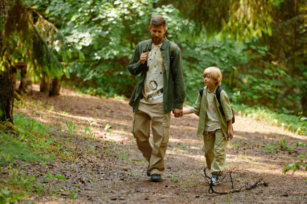 istock Exploring Nature During Father and Son Hike in Forest 2169434202