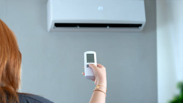 istock young woman using air condition  at home 2169436722