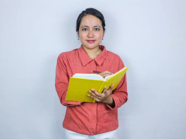 istock beautiful asian woman hold book planner first writing notes isolated over white background 2169437616