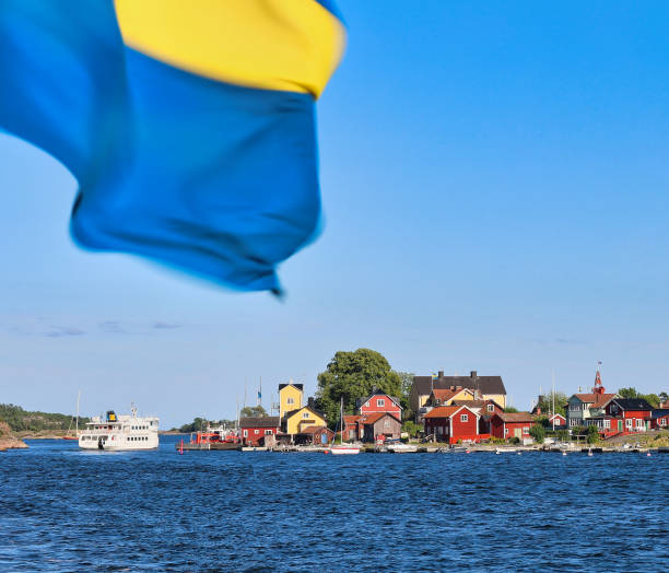 Old wooden houses in Sandhamn on the Stockholm archipelago island of Sandön, Sweden, June 2024, as seen from the sea.