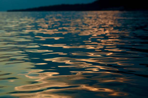 istock Abstract drawings by sunset on a water surface 2169441481