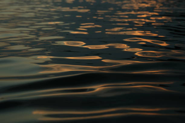 istock Abstract drawings by sunset on a water surface 2169441513