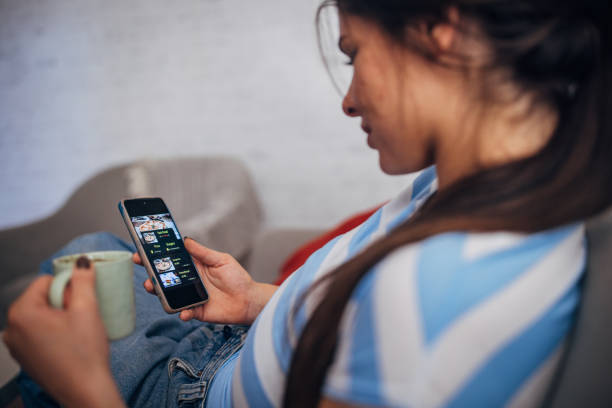 istock Individual scrolling a mobile app while lounging at home. 2169441737
