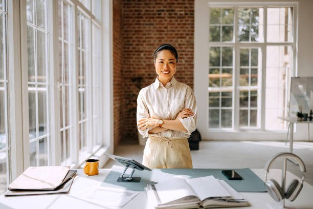 istock Smiling beautiful businesswoman posing while working at modern office 2169444474