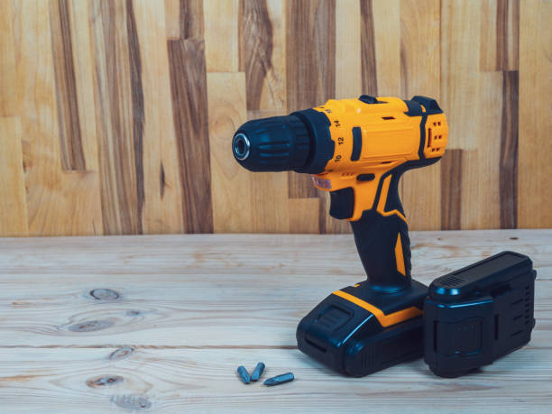 istock A screwdriver-drill against a wood background, ready for work, is ideal for repairs and construction in the country or at home 2169445027
