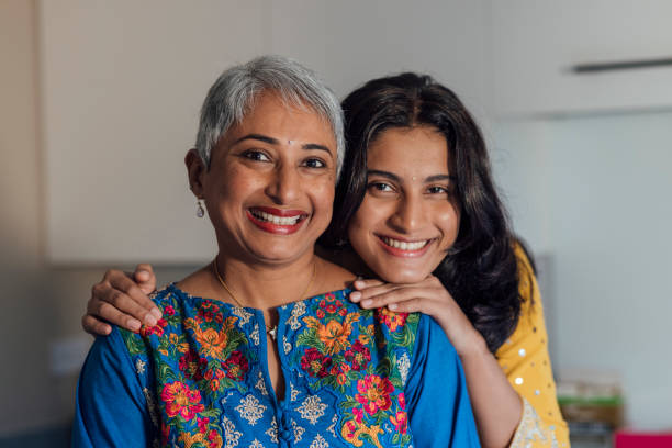Celebrating Diwali at Home Close up waist up view of a portrait of a real mother and daughter celebrating Diwali in a family home in Newcastle, England. They are wearing traditional Indian clothing and smiling while looking at the camera. The daughter has her arms around her mother.
Videos similar to this scenario also available. indian wedding stock pictures, royalty-free photos & images