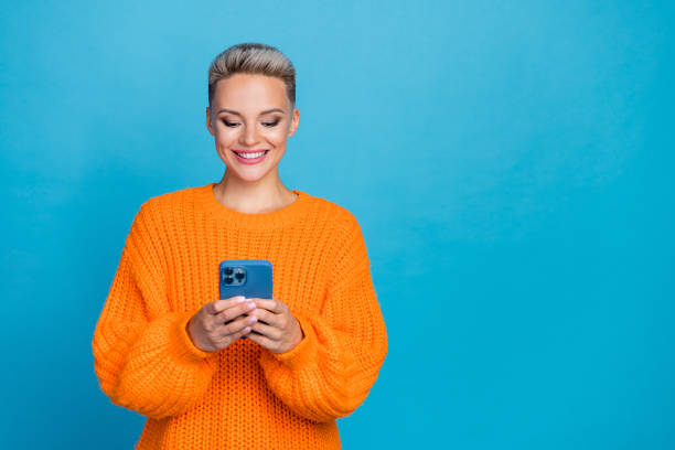 istock Photo of cute sweet woman dressed knitted pullover typing modern device empty space isolated blue color background 2169446524