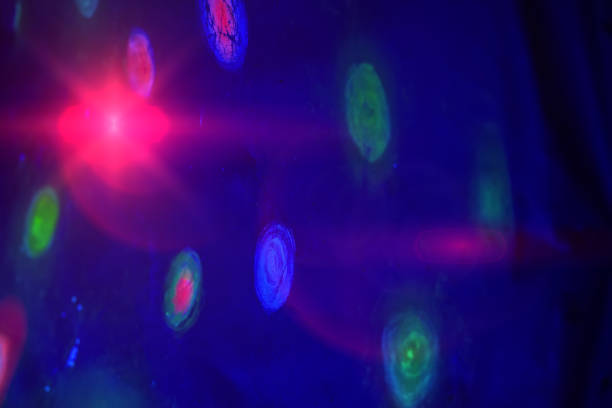 Abstract spots are a glowing blue-red sphere on a dark background.