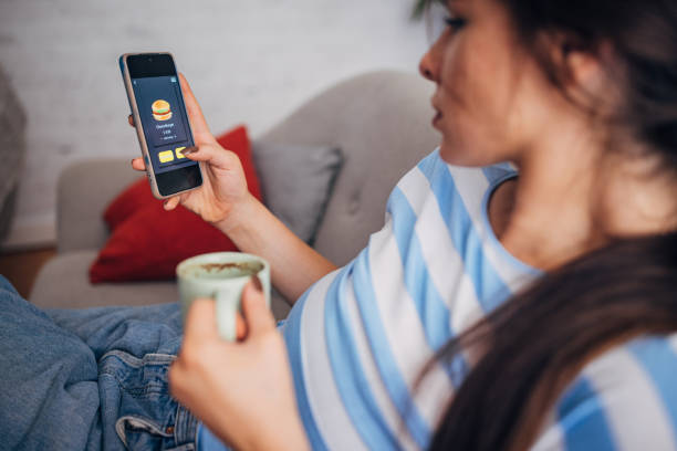 istock User interacting with a food menu app on their phone. 2169447058