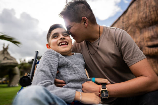 Father and son with physical disability enjoying the zoo