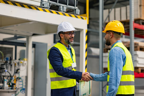 istock Engineer shaking hands with project manager in modern industrial factory, talking about new production project. Team management in manufacturing facility. 2169448981