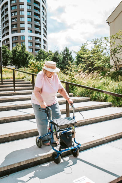 istock Elderly woman walking down the stairs with rollator, running errands. 2169450347