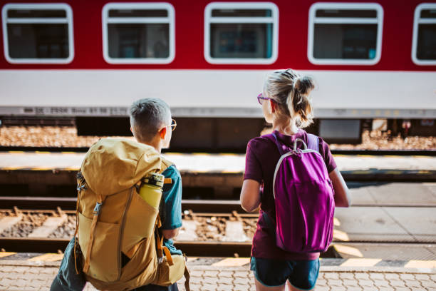 istock Siblings waiting for train, standing on platform. Family going on hike, using public transport. 2169450850