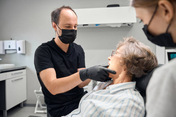 istock Dentist examines an elderly womans teeth during a medical appointment 2169451542