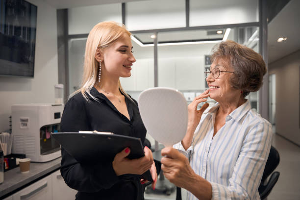 istock Patient admires her smile in the mirror 2169451926