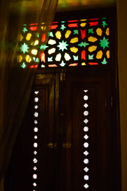 istock Window with Arabic colored lattice, soft curtain dropped on side and dim light 2169451949
