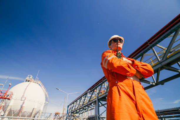 Gasoline tanker, oil storage tank, oil drilling rig, technological area, Sakhalin island. Blue sky, dirty earth road with tracks