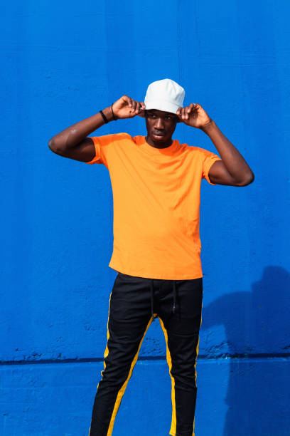 istock Black man in bright sporty outfit and cap 2169456683