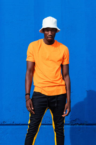 istock Black man in bright sporty outfit and cap 2169456731