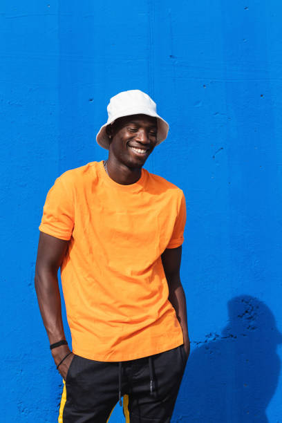 istock Black man in bright sporty outfit and cap 2169456734