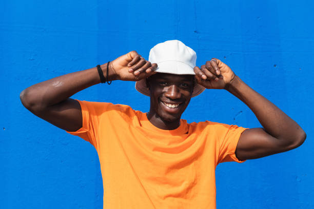 istock Black man in bright sporty outfit and cap 2169456740
