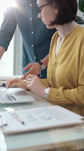 istock Team collaboration over financial reports. Business people, professionals analyzing financial charts and data on a desk near a laptop computer in flair office 2169456887