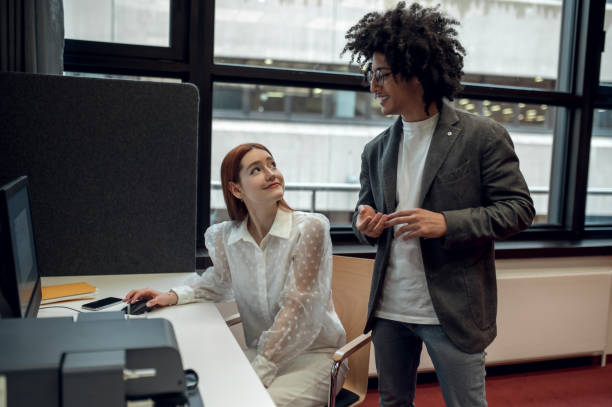 istock Young people talking, smiling and looking involved 2169459211