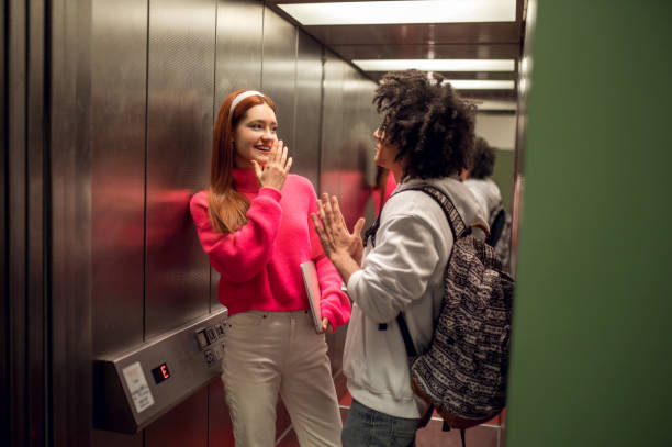 istock Young people using the elevator to get to the library archive 2169459240