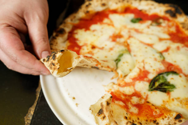 istock Chef showing cheese pizza crust filled with air 2169459472