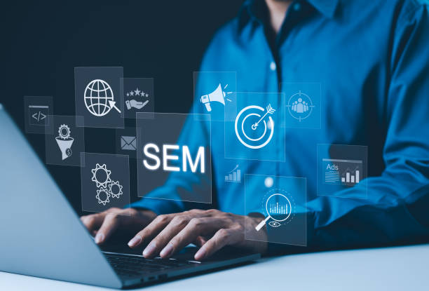 istock SEM Search Engine Marketing Concept. Businessman is working with virtual icons, search engine marketing, target, analytics, gears, ads, and global reach, digital marketing strategies. Online, SEO, 2169459738