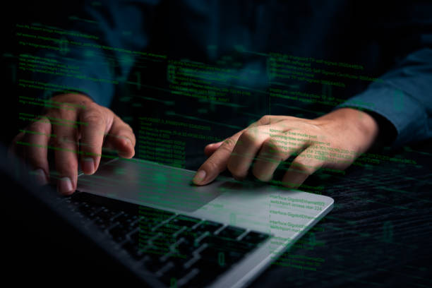 istock A close-up of hands typing on a laptop keyboard with digital code overlay, representing software development, cybersecurity, or hacking activities. Technology, IT development, cybersecurity. 2169462072