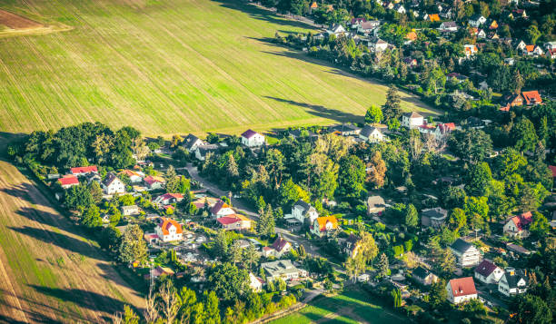 An aerial view of detached houses among woodland and field in Germany.