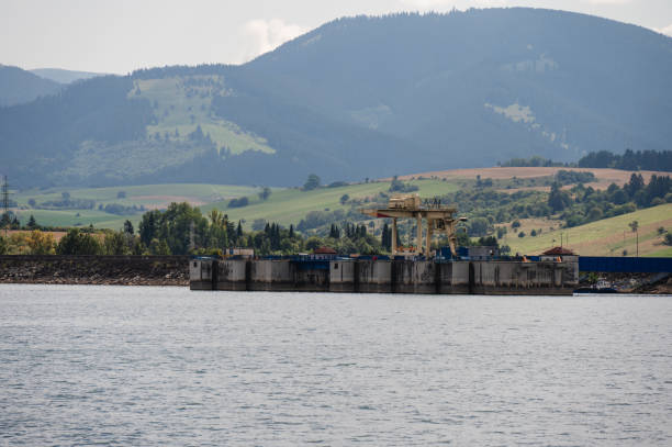 istock Industrial structure on lake with mountain backdrop 2169463950