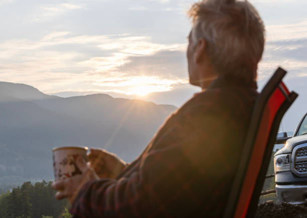 istock Mature man enjoys hot beverage at sunrise 2169464016
