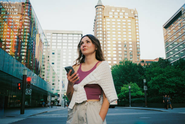 Woman using smartphone walking in Montreal, Canada