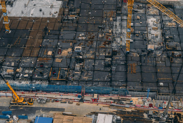 istock T/L Drone Point View of Workers Working on Construction Site 2169470302